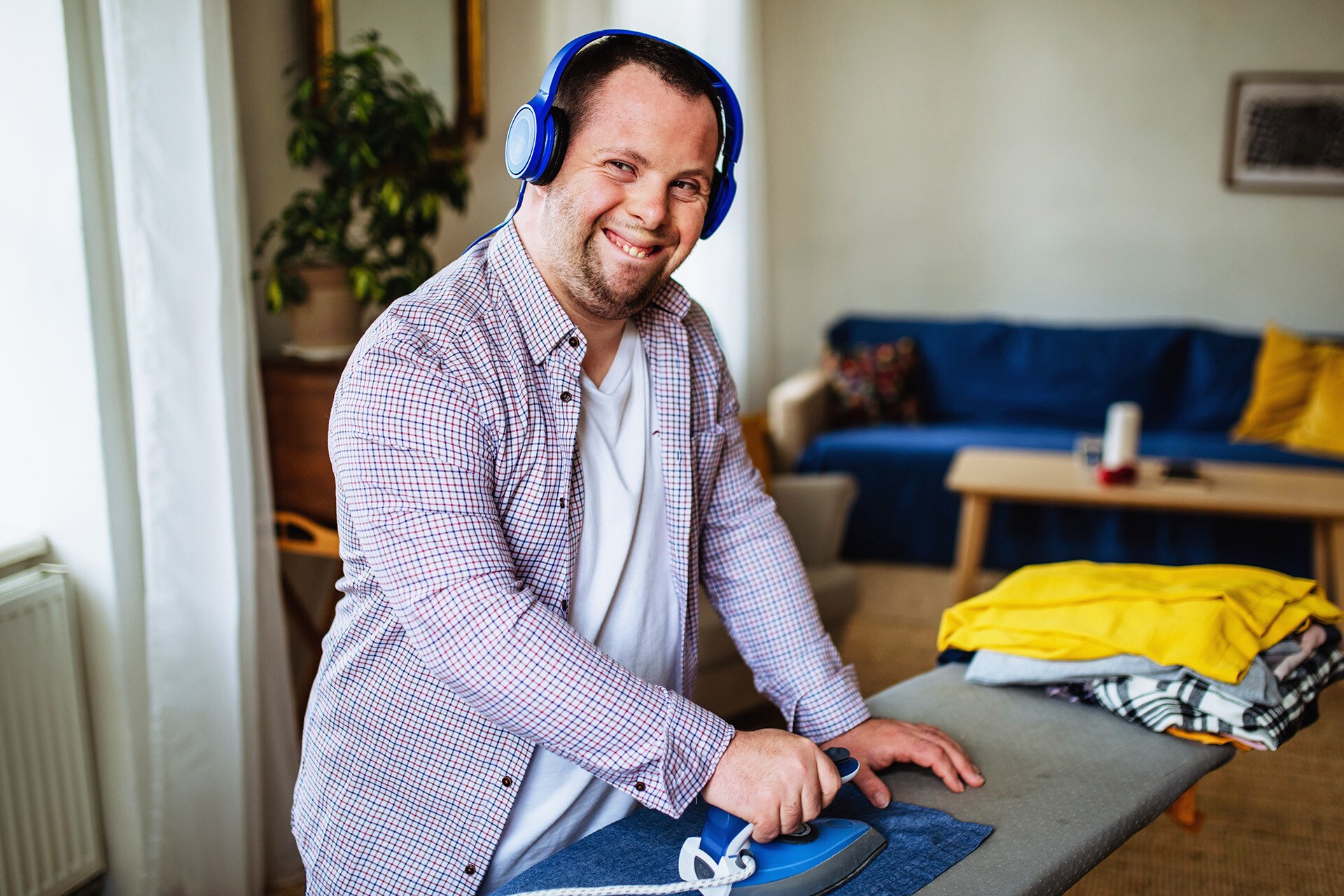 ndis customer at home ironing his clothes